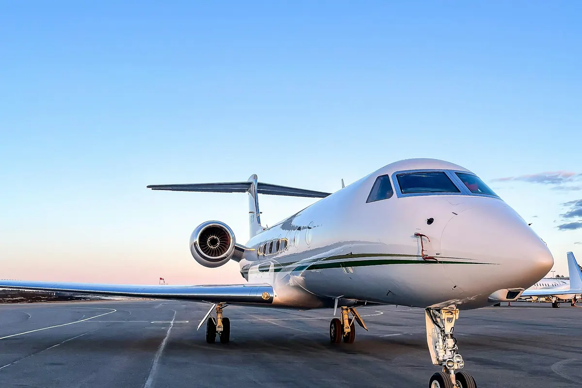 Business jet on a ramp at sunset