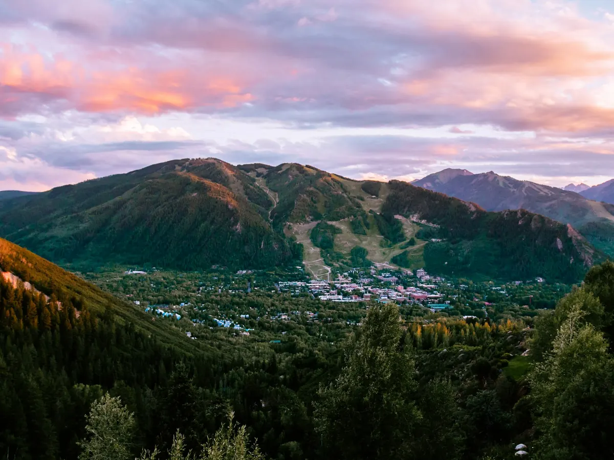 Aspen at sunset with mountains behind the town